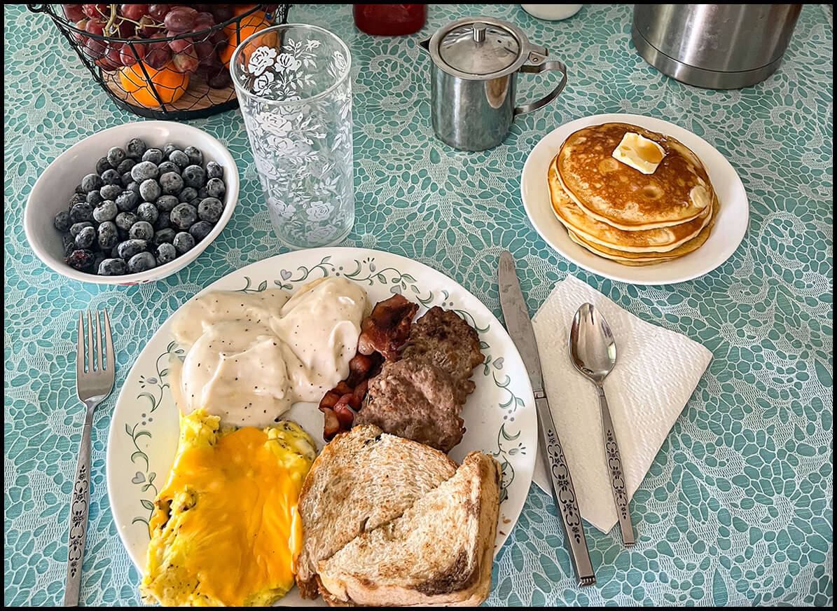 Table of Breakfast Foods on Blue Fancy Tablecloth