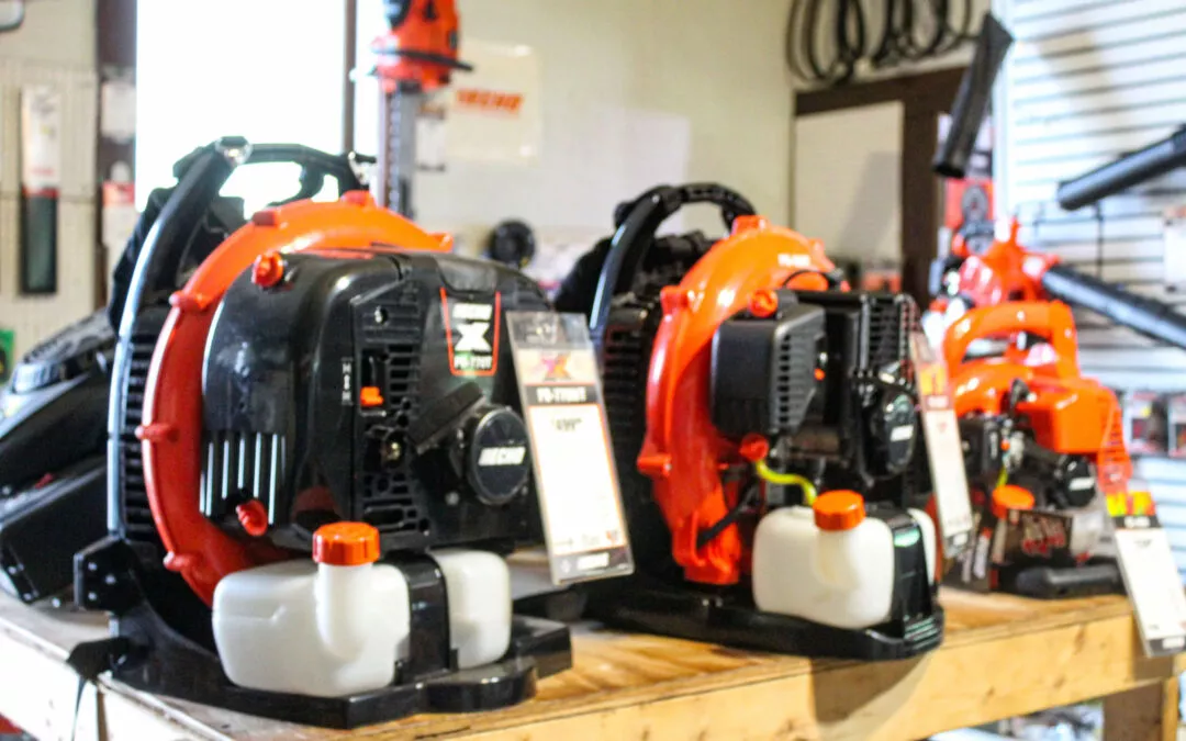 C.S. Small Engine Services Mill Hall PA Husqvarna chainsaws and blowers in a shop.