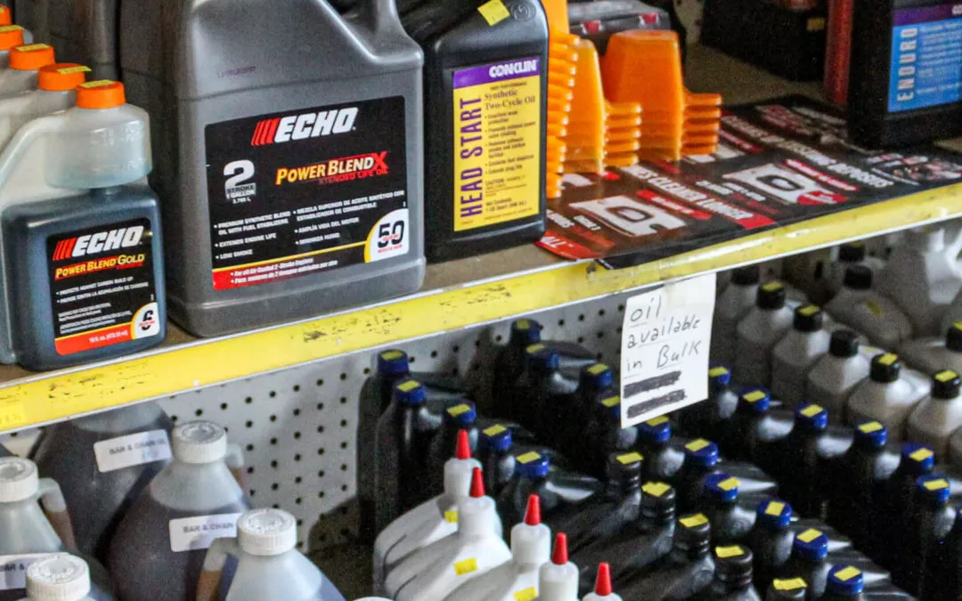 C.S. Small Engine Services Mill Hall PA A shelf full of oil jugs in a store.