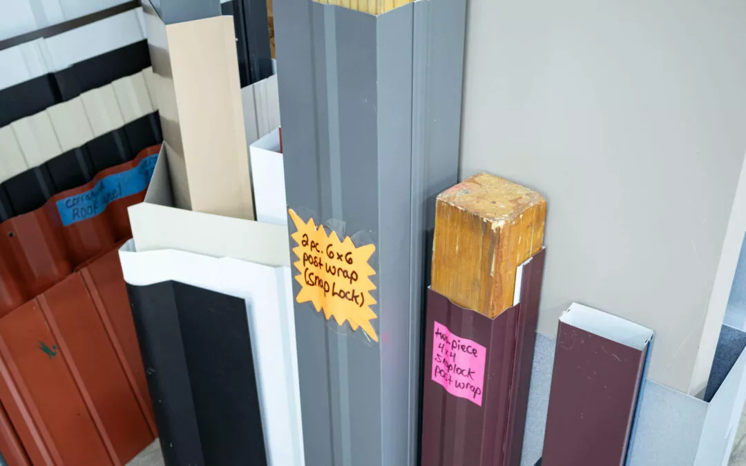 Martin's Trim Forming Millmont, PA Various metal roofing materials in different colors and sizes are displayed upright. Handwritten labels on orange sticky notes indicate sizes and prices.