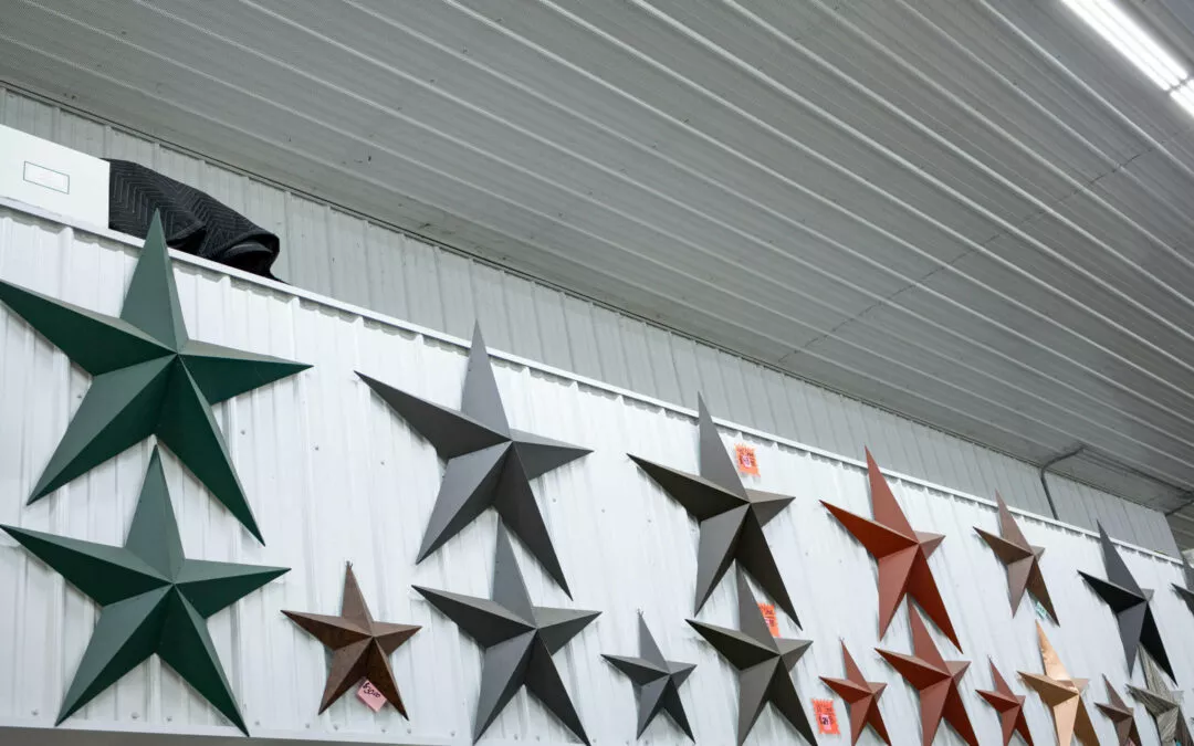 Martin's Trim Forming Millmont, PA A corrugated metal wall adorned with variously colored star-shaped decorations in different sizes.