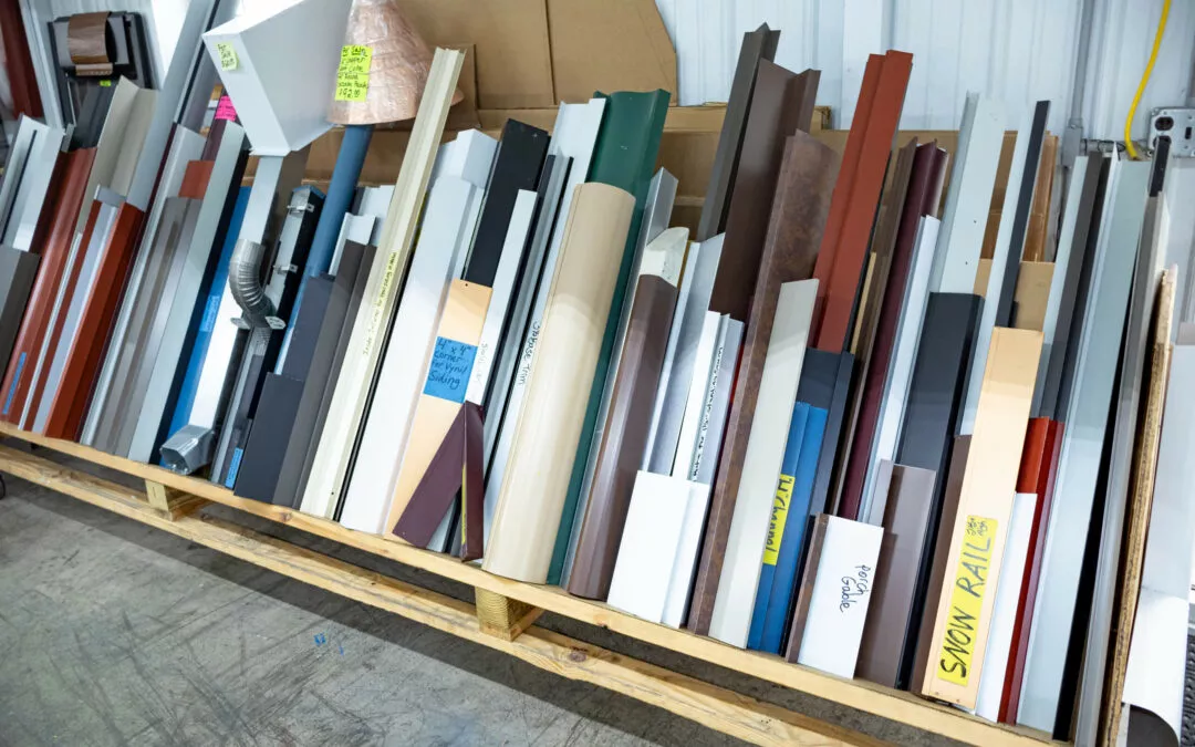 Martin's Trim Forming Millmont, PA Assorted metal strips and panels of various colors and sizes are organized in a wooden storage rack in a warehouse.