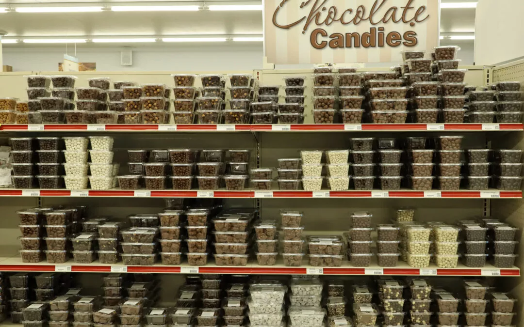 Lakeside Country Store Mishicot, Wisconsin Shelves in a store display various containers of chocolate candies organized by type and size.