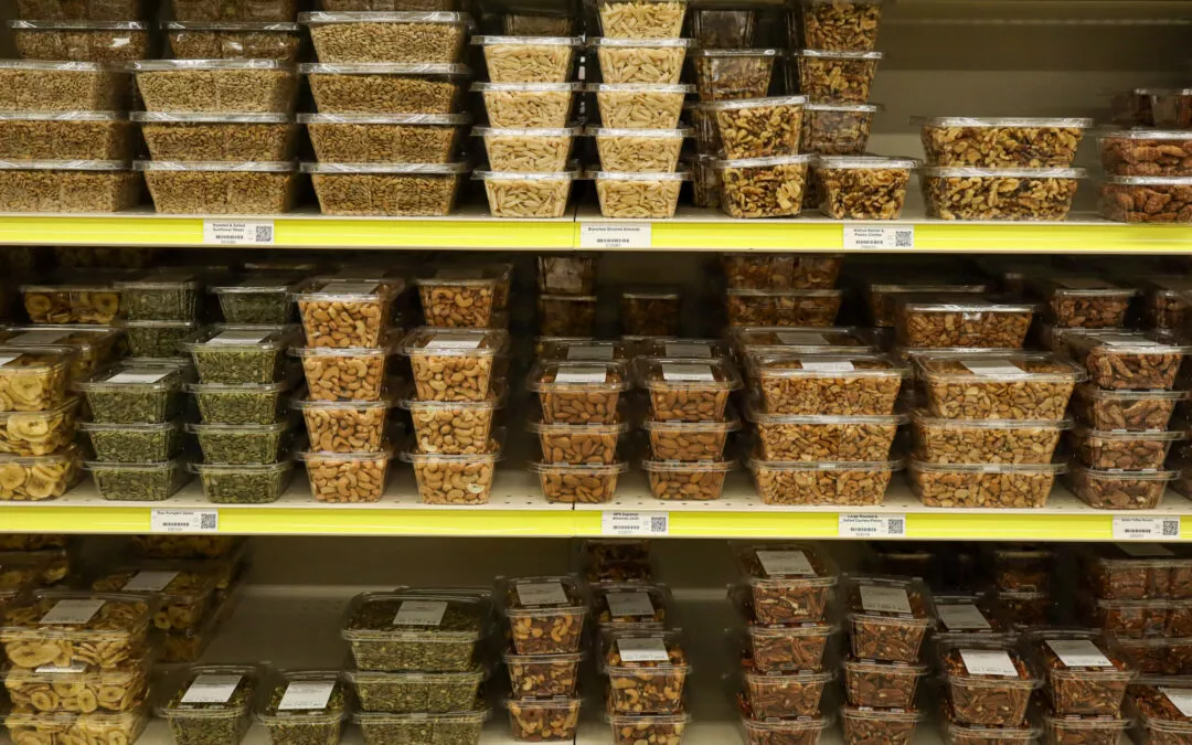Lakeside Country Store Mishicot, Wisconsin Shelves stocked with various plastic containers of dried fruits, nuts, and seeds in a grocery store.