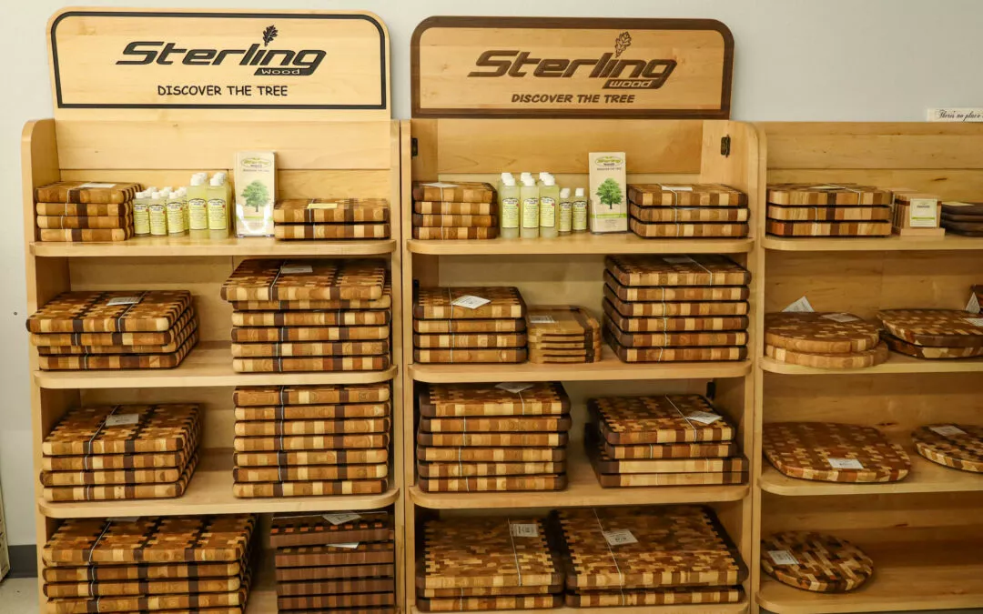 Lakeside Country Store Mishicot, Wisconsin Display shelves with "Sterling Wood" cutting boards and a few bottles of natural wood conditioner. The shelves are filled with various sizes and shapes of cutting boards.