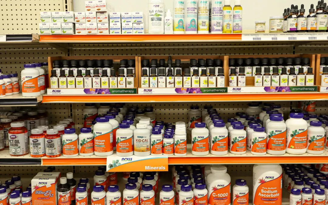 Lakeside Country Store Mishicot, Wisconsin Shelves filled with various health supplements, vitamins, and aromatherapy products in bottles and boxes, organized under labeled sections.