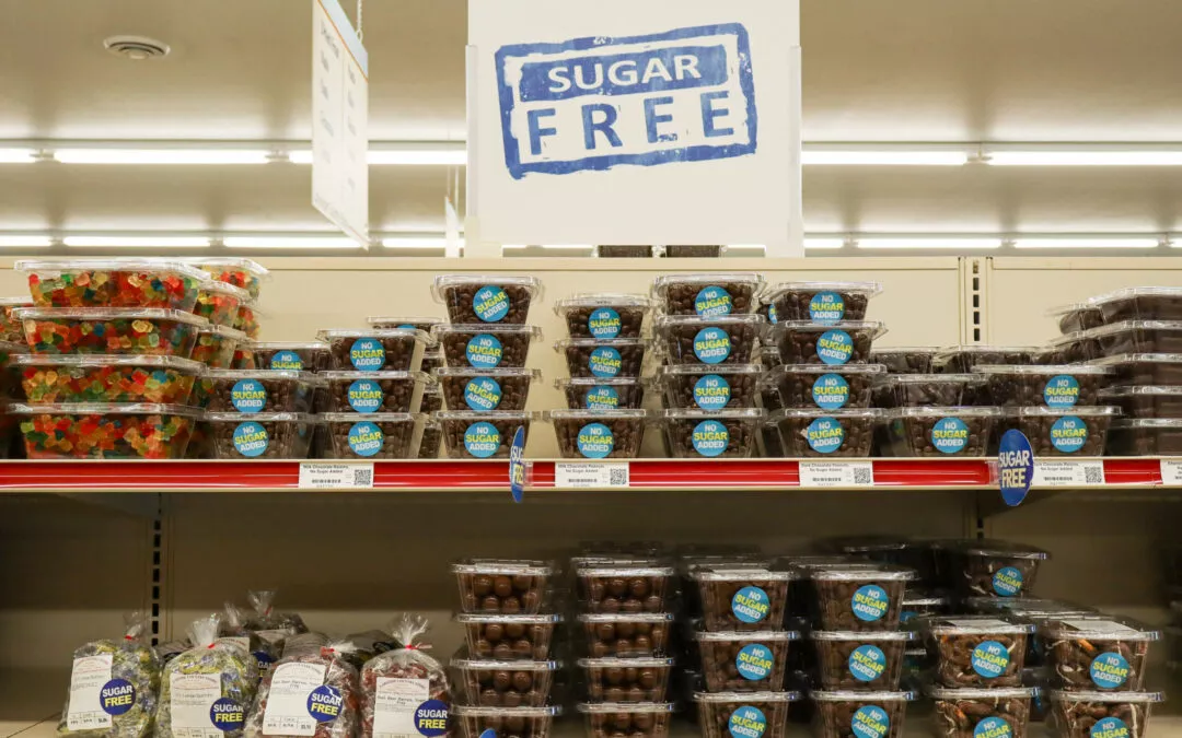 Lakeside Country Store Mishicot, Wisconsin Shelves in a store display various sugar-free candy products in clear plastic containers, marked with a blue "Sugar Free" sign on top.