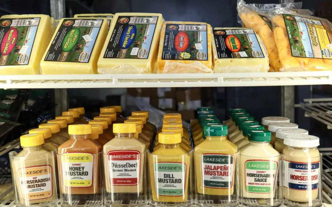 Lakeside Country Store Mishicot, Wisconsin Shelves stocked with assorted Lakeside's mustard bottles and different types of cheese.