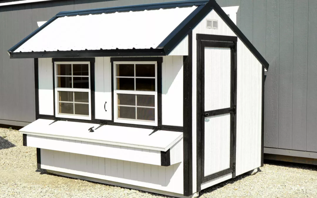 Cedar Ridge Sales Ramsey IL Ava IL A small white and black shed with two windows, a door on the right, and a fold-down workbench beneath the windows.