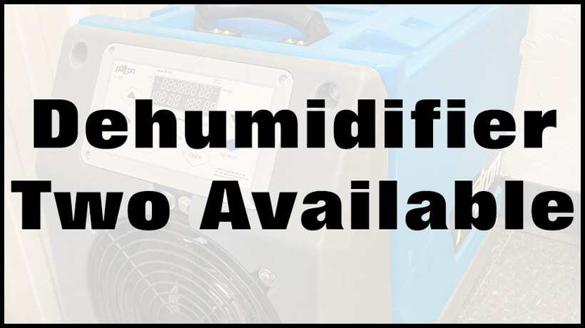 Close-up of a dehumidifier with a display and buttons, overlaid with large text: "Dehumidifier Two Available.