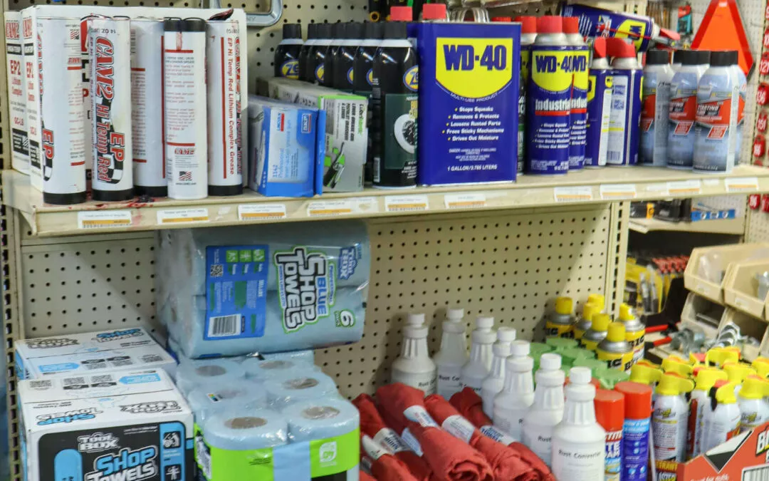Chippewa Vallaey Dairy Supply Stanley, WI A store shelf displaying various tools and supplies, including caulking guns, paintbrushes, cleaning products, spray cans, and red cloths.
