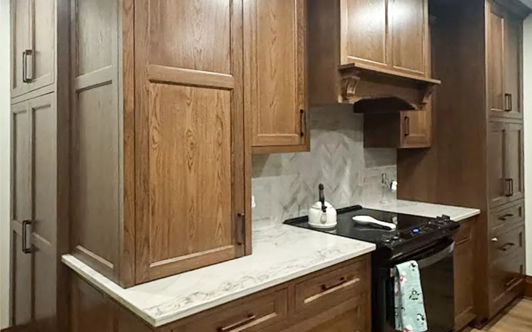 The Woodpecker Sullivan, Illinois A kitchen with wooden cabinets, marble countertops, an electric stove, a kettle, and a towel hanging from the oven handle.