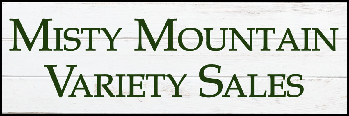 A white wooden sign with green text that reads 