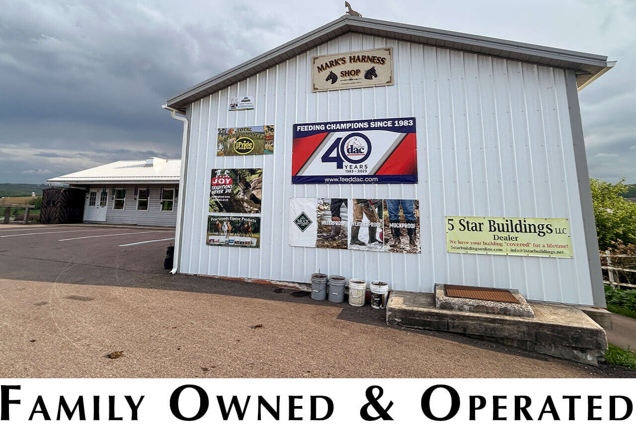 Mark's Harness Shop Springs, PA Exterior of a white building with various business signs on the wall, including one for Mark's Harness Shop, with "Family Owned & Operated" text at the bottom of the image.