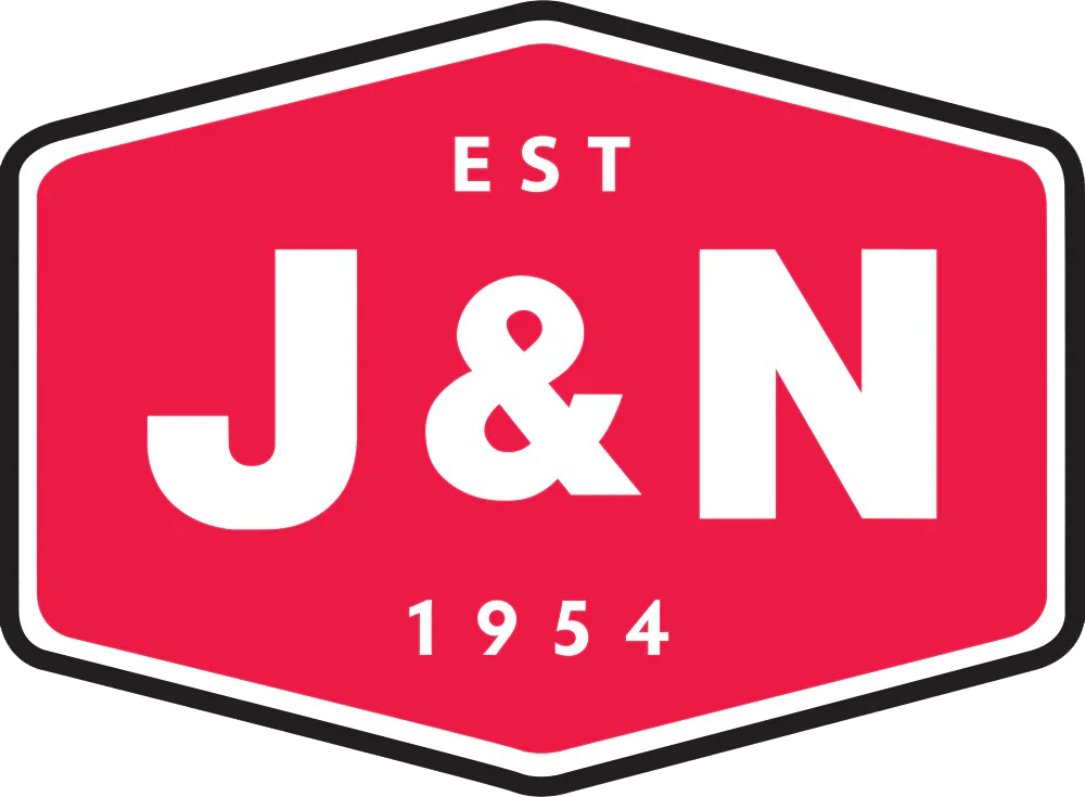 A red hexagonal logo with "EST J&N 1954" in white text, featuring a bold, sans-serif font.