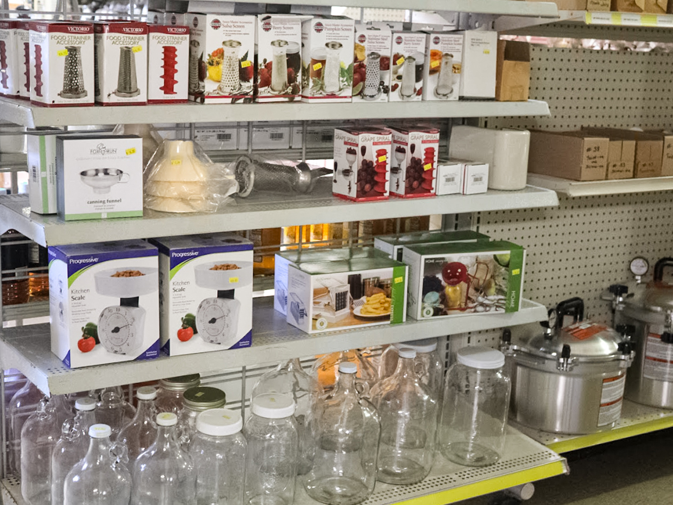 Country Variety Store Bellafontaine OH Shelves display kitchen appliances, food processing equipment, glass jars, and boxes in a store aisle.