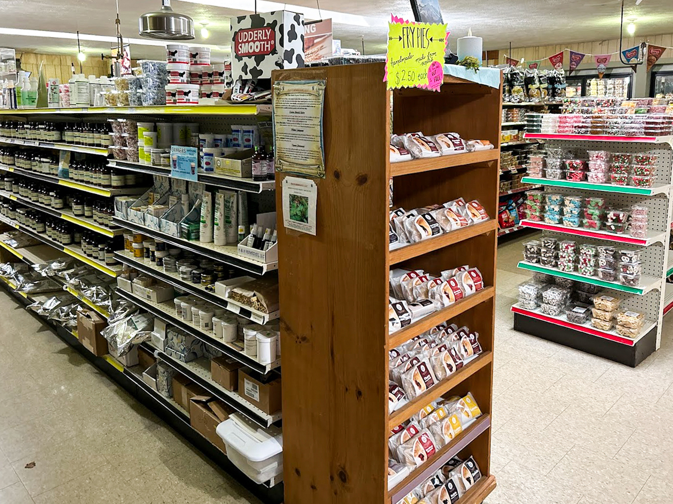 Country Variety Store Bellafontaine OH A grocery store aisle displays shelves stocked with packaged foods, baking supplies, spices, and assorted kitchen goods under fluorescent lighting.