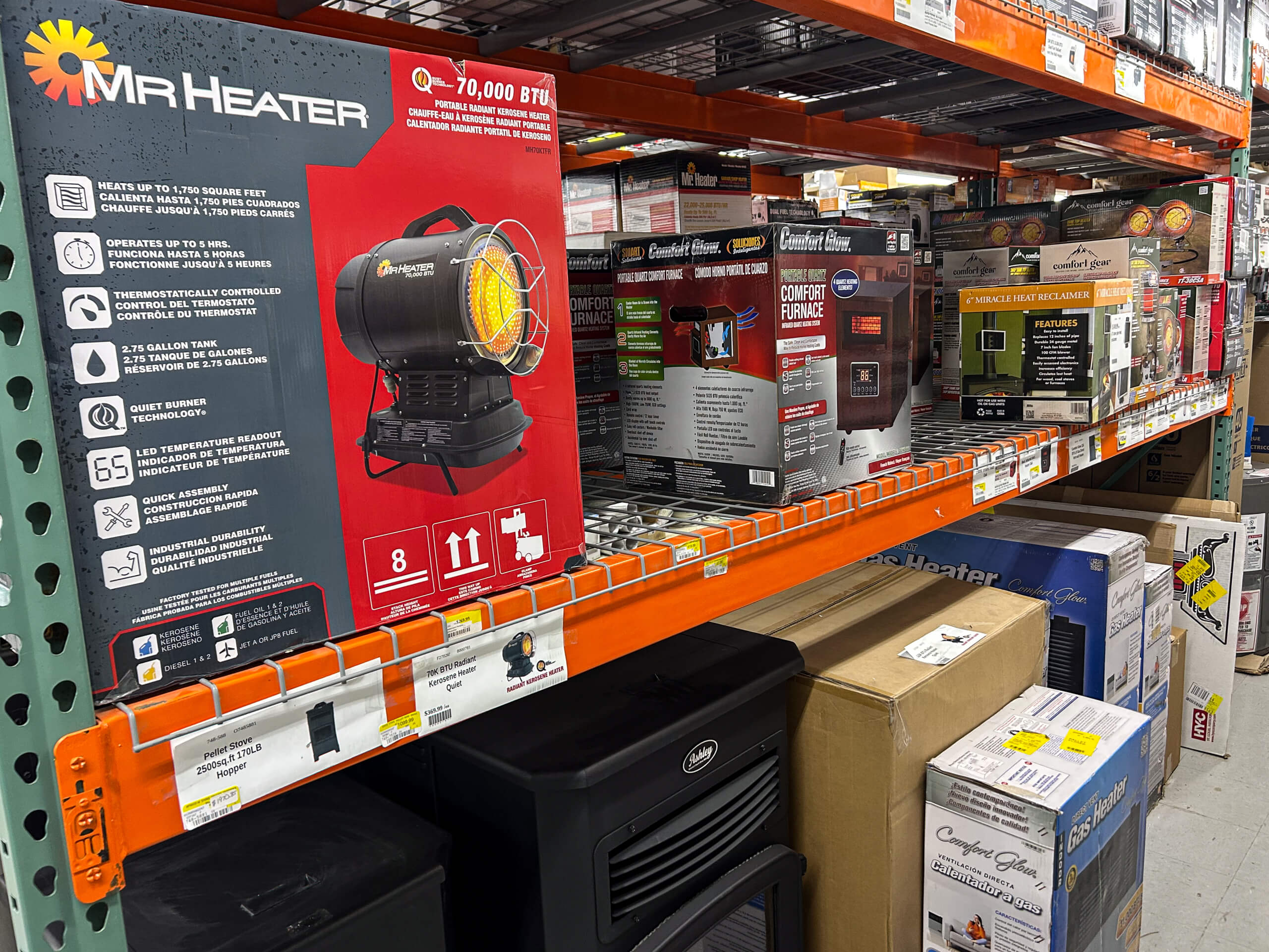 Benny's Hardware Barnett MO Store shelf displaying several portable heaters in boxes, including a prominent Mr. Heater propane heater and other brands, with product information and prices visible.
