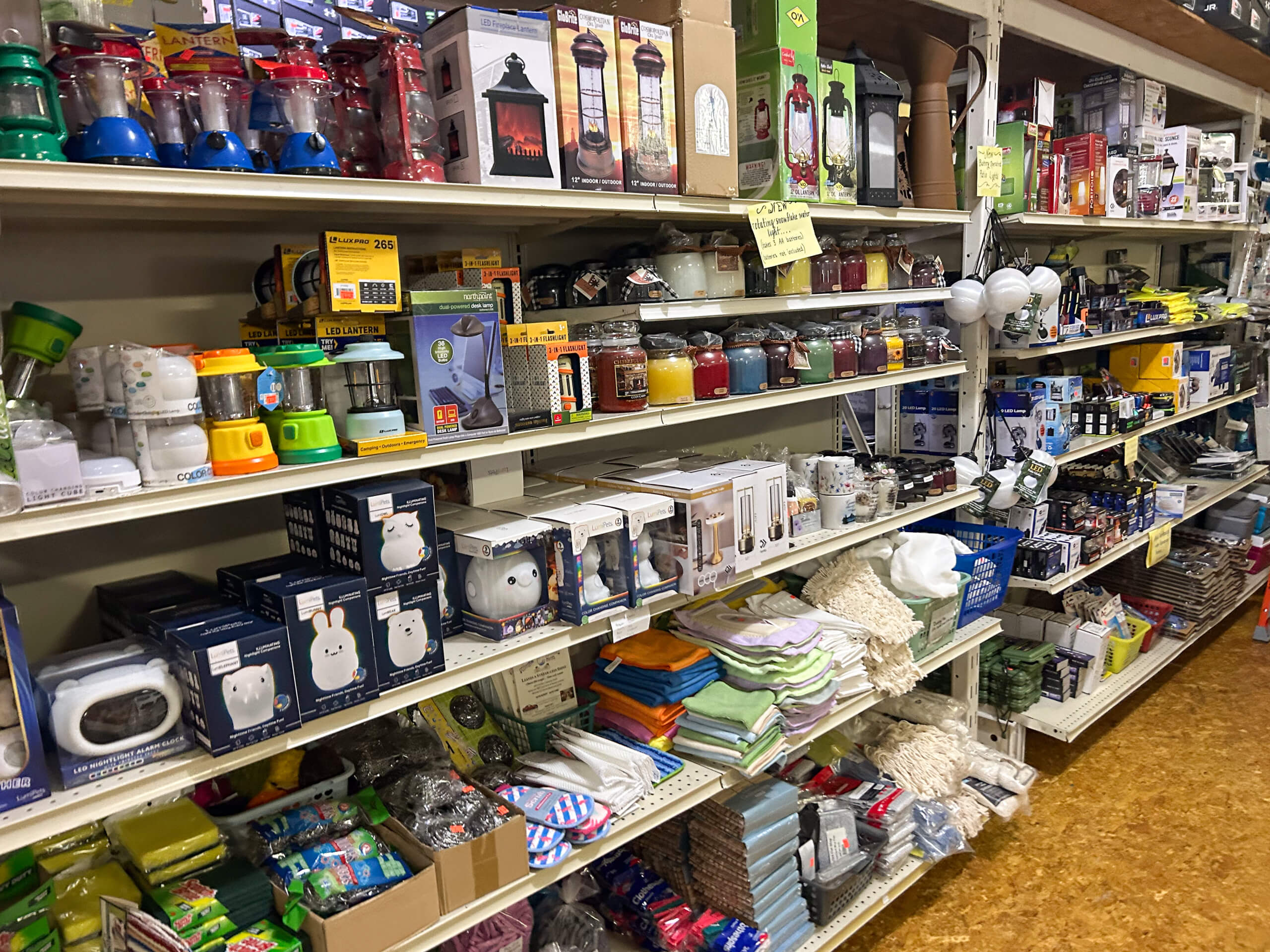 Miller's Country Store Grabill IN Store shelves stocked with lanterns, flashlights, jars, small appliances, towels, and various household items.