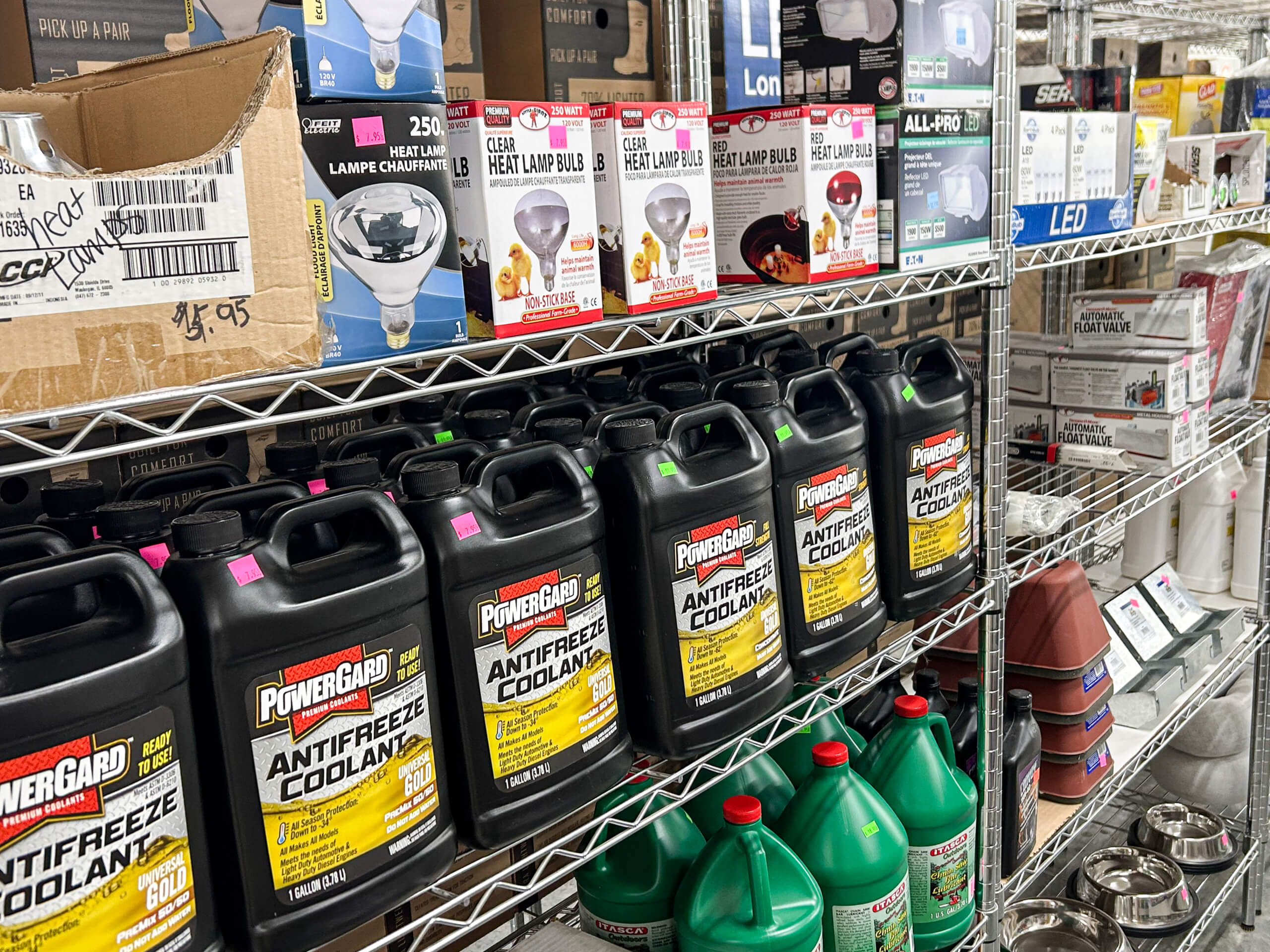 Graber Farm & Home Center Odon Indiana Shelves stocked with antifreeze coolant containers, light bulbs, and various automotive and electrical products in a store.