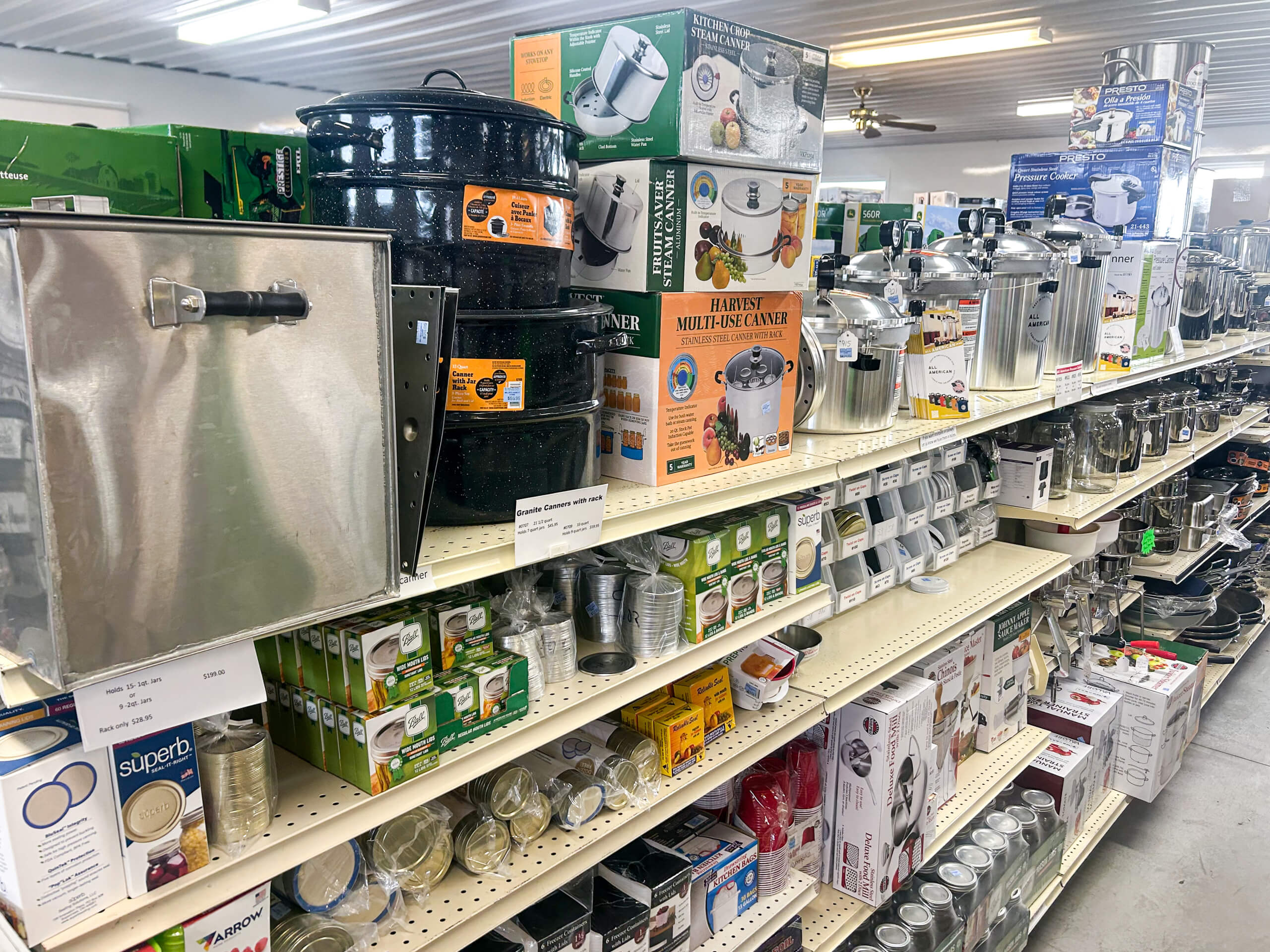 Miller's Variety Store Etna Green, IN Store shelves stocked with canning supplies, including glass jars, large pots, lids, pressure canners, and various food preservation equipment.