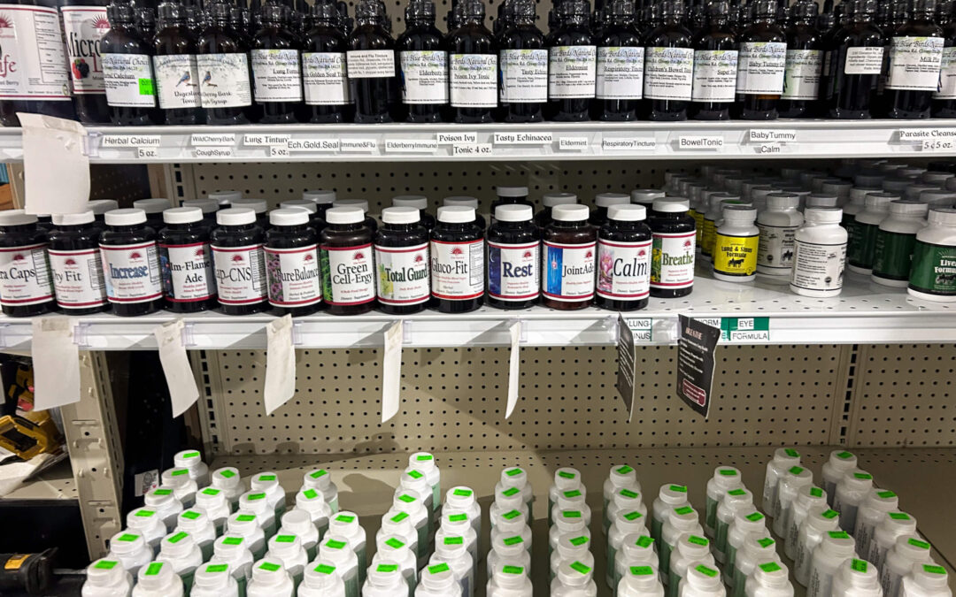 Shetler's Supplies Hardware Variety Bulk Foods Greenville PA Shelves stocked with various bottles of herbal supplements and vitamins, organized in rows in a retail store.