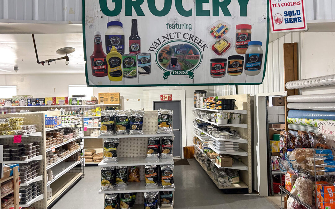 Shetler's Supplies Hardware Variety Bulk Foods Greenville PA A grocery store aisle with shelves stocked with various products, a large Walnut Creek Foods sign overhead, and a “Tea Coolers Sold Here” sign on the wall.