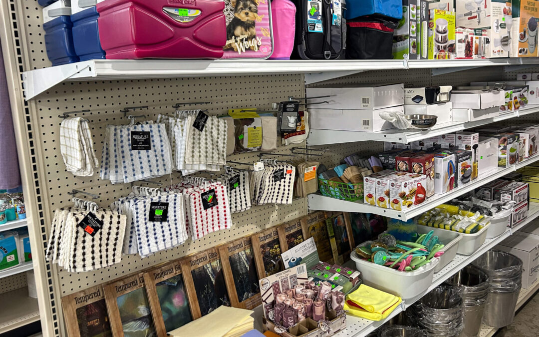 Shetler's Supplies Hardware Variety Bulk Foods Greenville PA Shelves in a store display various household items including storage containers, kitchen gadgets, towels, candles, and cleaning supplies.