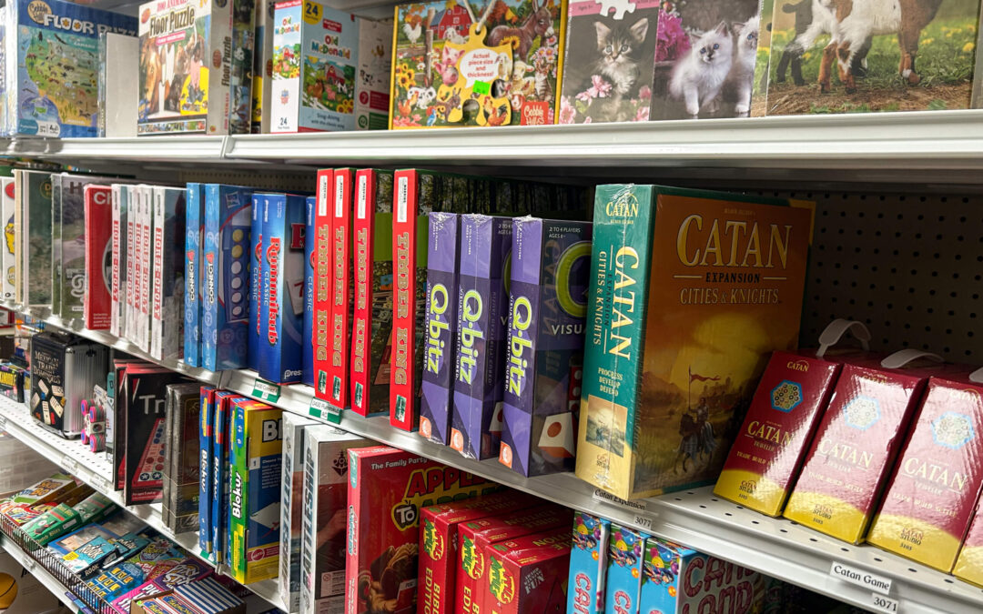 Shetler's Supplies Hardware Variety Bulk Foods Greenville PA Shelves stocked with various board games and puzzles, including Catan, Qwirkle, and Candy Land, in a store aisle.