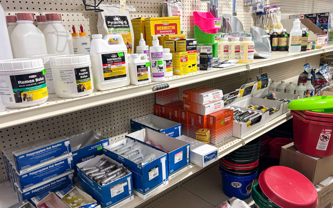Shetler's Supplies Hardware Variety Bulk Foods Greenville PA Shelves stocked with various livestock and animal health supplies, including medications, supplements, syringes, buckets, and cleaning products in a farm supply store.