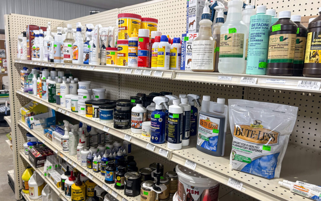 Shetler's Supplies Hardware Variety Bulk Foods Greenville PA Shelves in a store display various animal health and care products, including bottles, sprays, and powders, organized by type and brand.