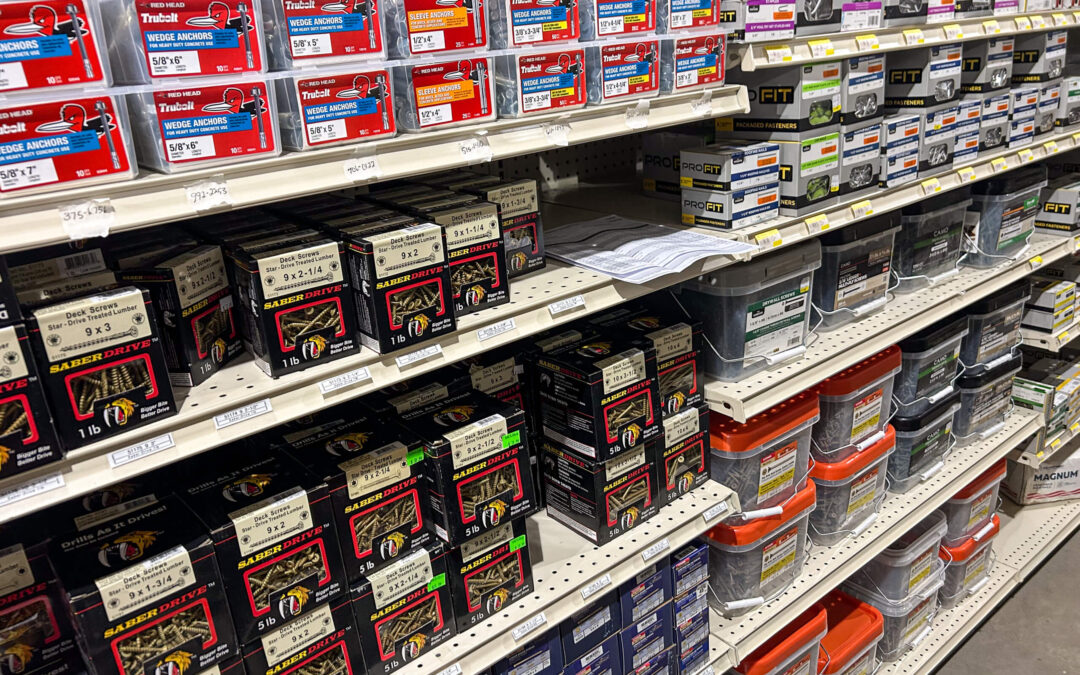 Shetler's Supplies Hardware Variety Bulk Foods Greenville PA Shelves stocked with various boxes of screws and fasteners, organized by type and size, in a hardware store aisle.