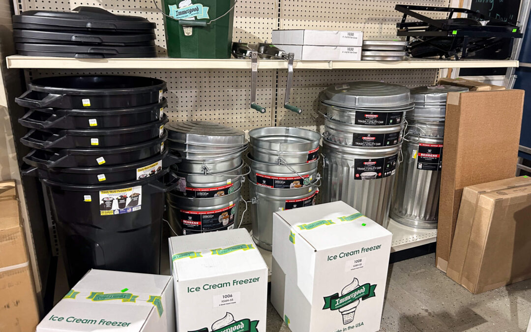 Shetler's Supplies Hardware Variety Bulk Foods Greenville PA A store shelf displays plastic and metal trash cans, ice cream freezer boxes, metal buckets, lids, and other storage containers.
