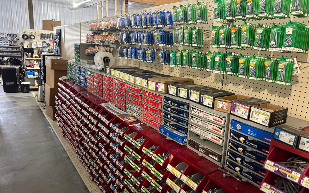 Shetler's Supplies Hardware Variety Bulk Foods Greenville PA A hardware store aisle with organized drawers of screws, bins of bolts, and various packs of fasteners hanging on a pegboard display.