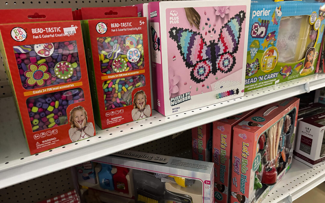 Shetler's Supplies Hardware Variety Bulk Foods Greenville PA Shelves display various children's craft kits, including bead sets, a butterfly mosaic, a Perler bead kit, and a toy makeup set in a store aisle.