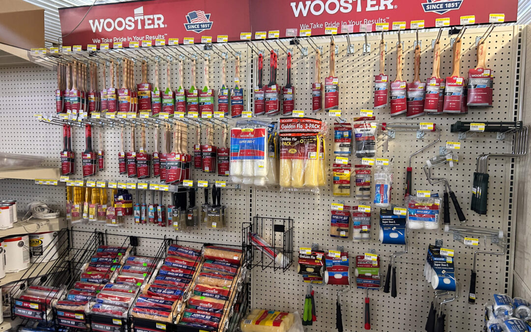 Shetler's Supplies Hardware Variety Bulk Foods Greenville PA Display of Wooster brand paint brushes, rollers, painter’s tape, and painting supplies on a pegboard wall in a hardware store.