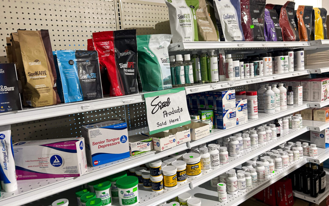 Shetler's Supplies Hardware Variety Bulk Foods Greenville PA Shelves stocked with various health and nutrition products, including supplements, powders, and bottles, with a sign reading “Sisel Products Sold Here.”.