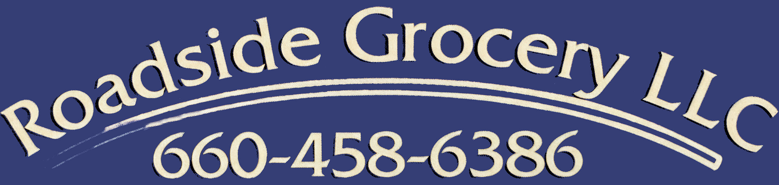 Sign with text "Roadside Grocery LLC" and phone number "660-458-6386" on a blue background.
