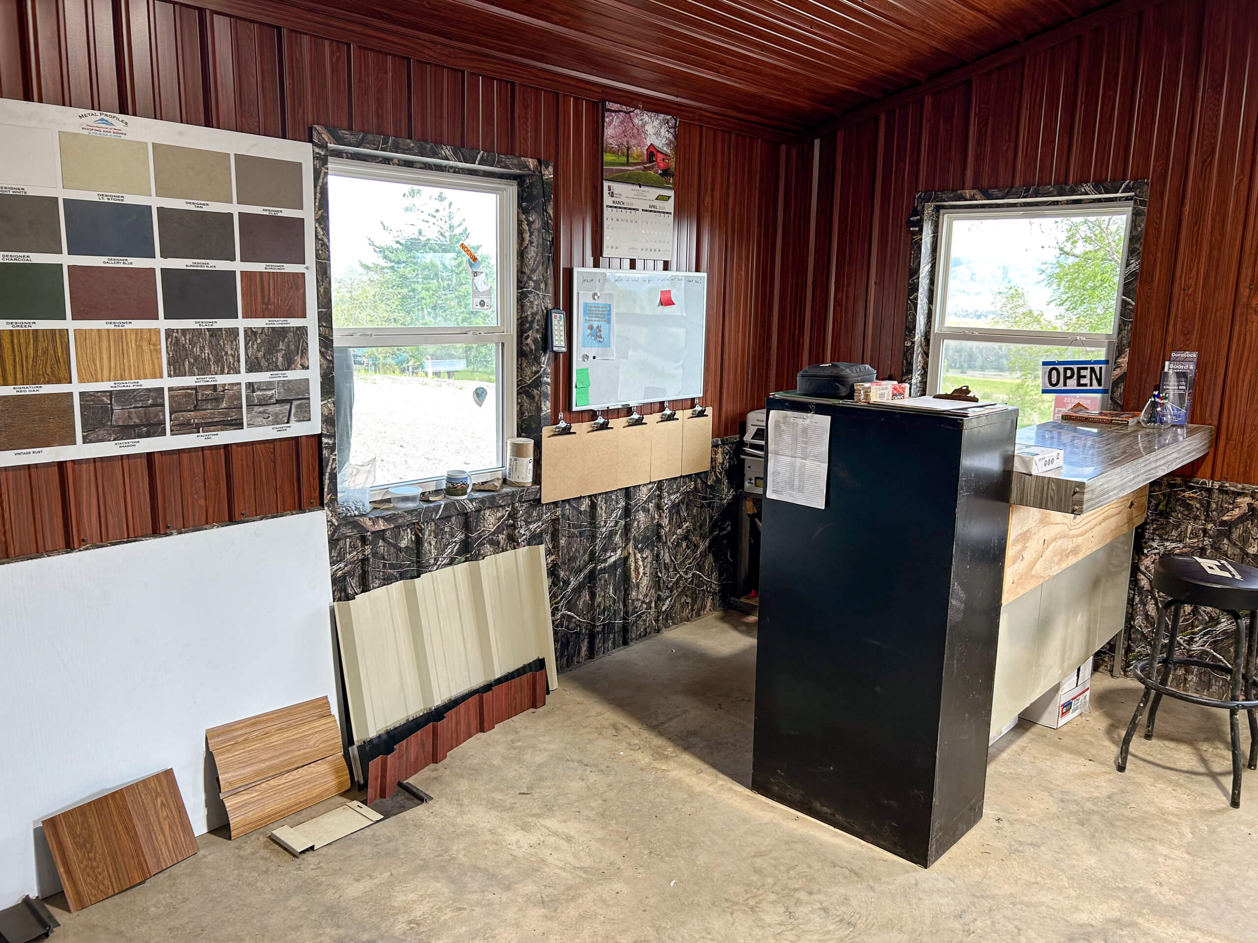 Metal Profiles Rose Hill, VA Small sales office with a counter, sample boards of wood finishes, a color swatch display, and an open sign in the window.