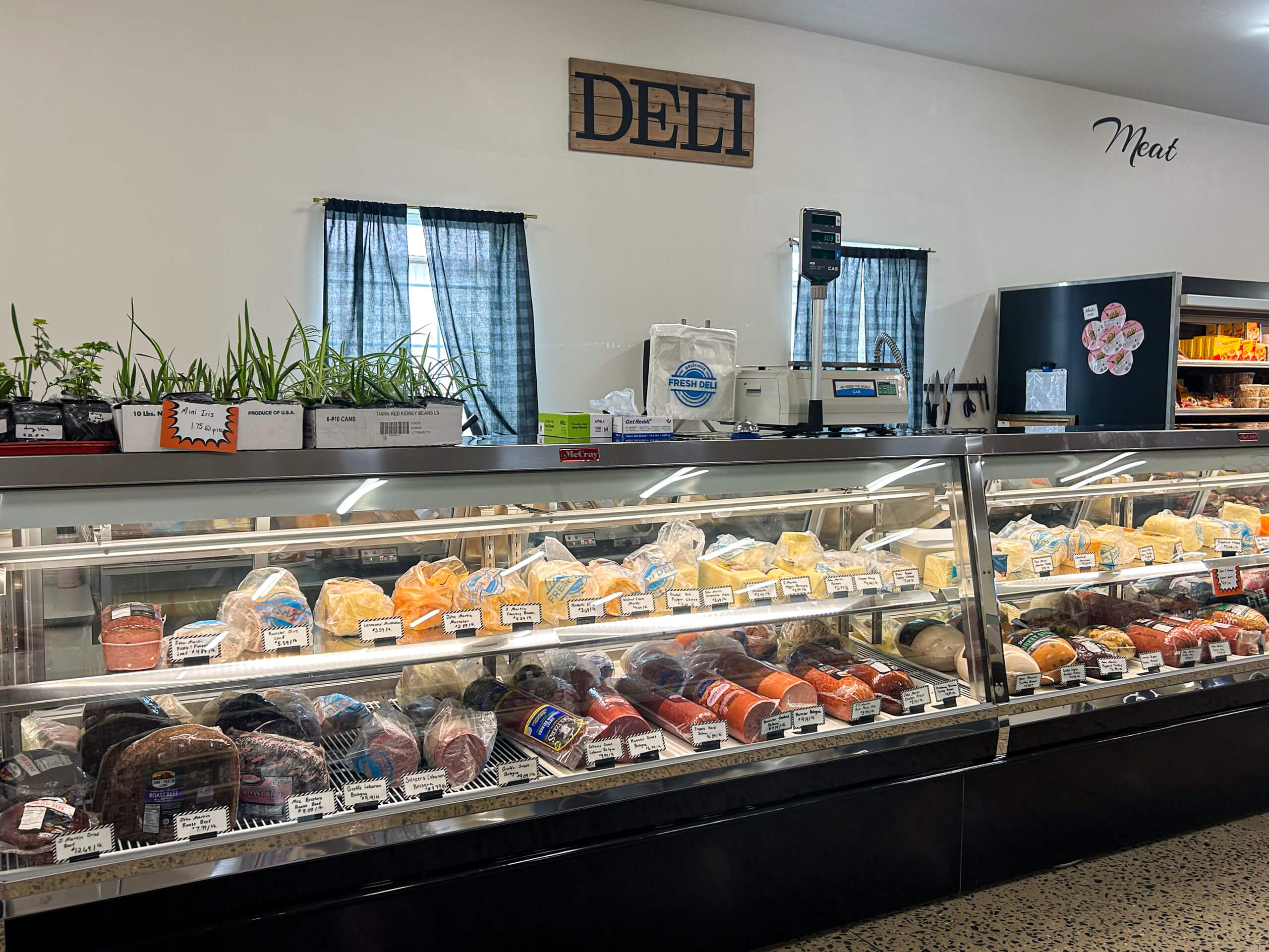 Jamar Groceries Kutztown PA a display of of different types of amish cheese