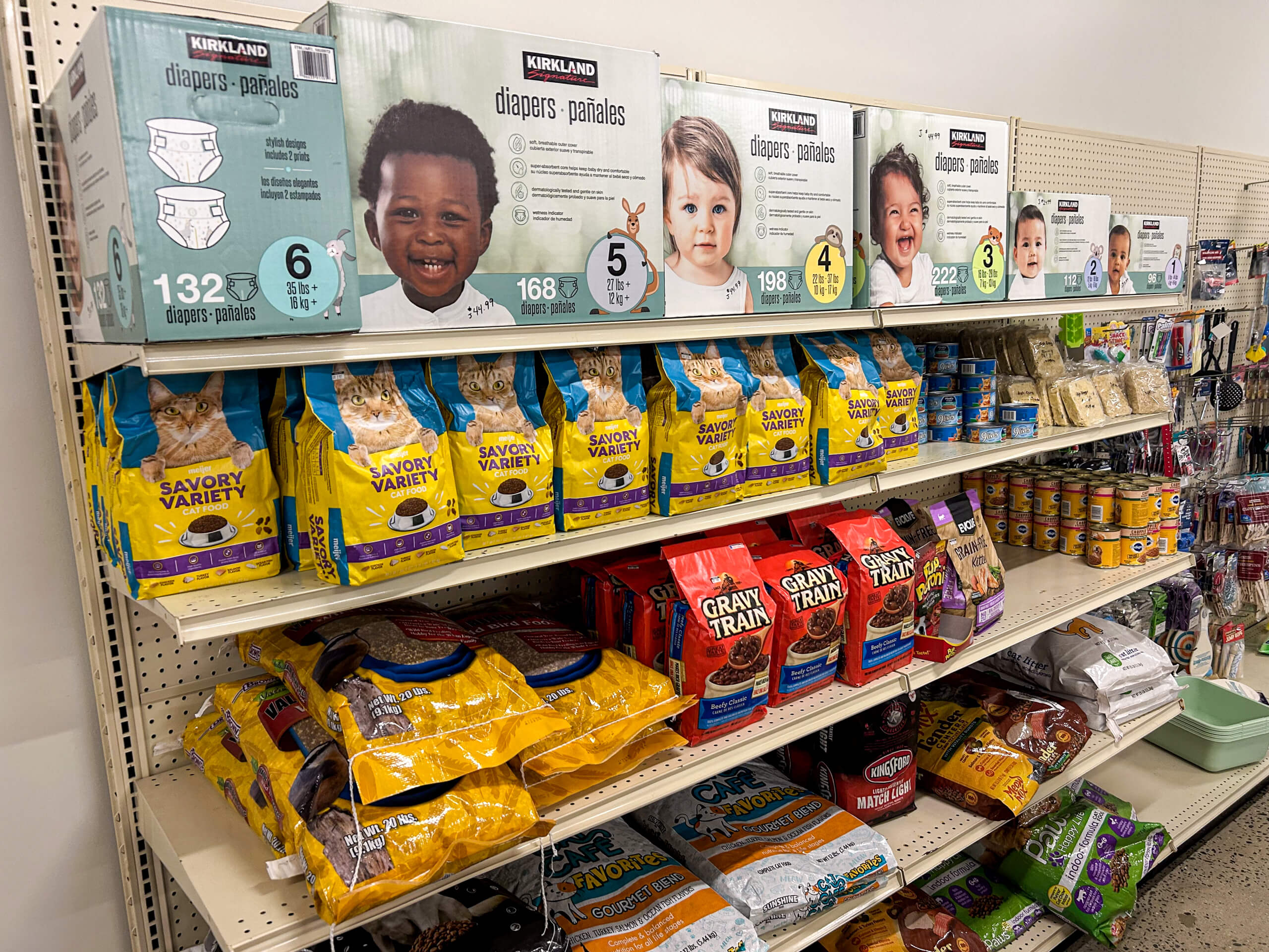Jamar Groceries Kutztown PA Store shelves stocked with Kirkland diapers on the top row and various brands of dog food and pet supplies on the lower rows.
