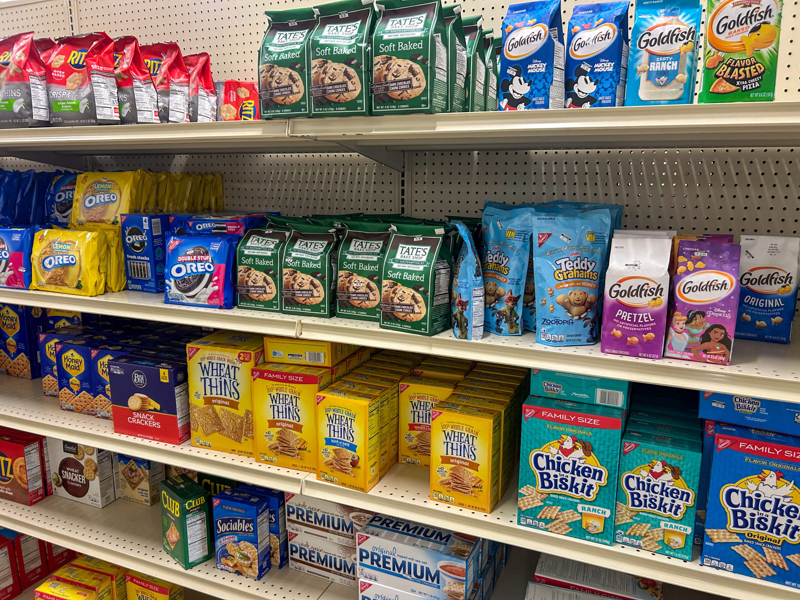 Jamar Groceries Kutztown PA Shelves in a grocery store displaying various crackers and cookies, including Wheat Thins, Chicken in a Biskit, Oreos, Tate’s cookies, Teddy Grahams, and Goldfish.
