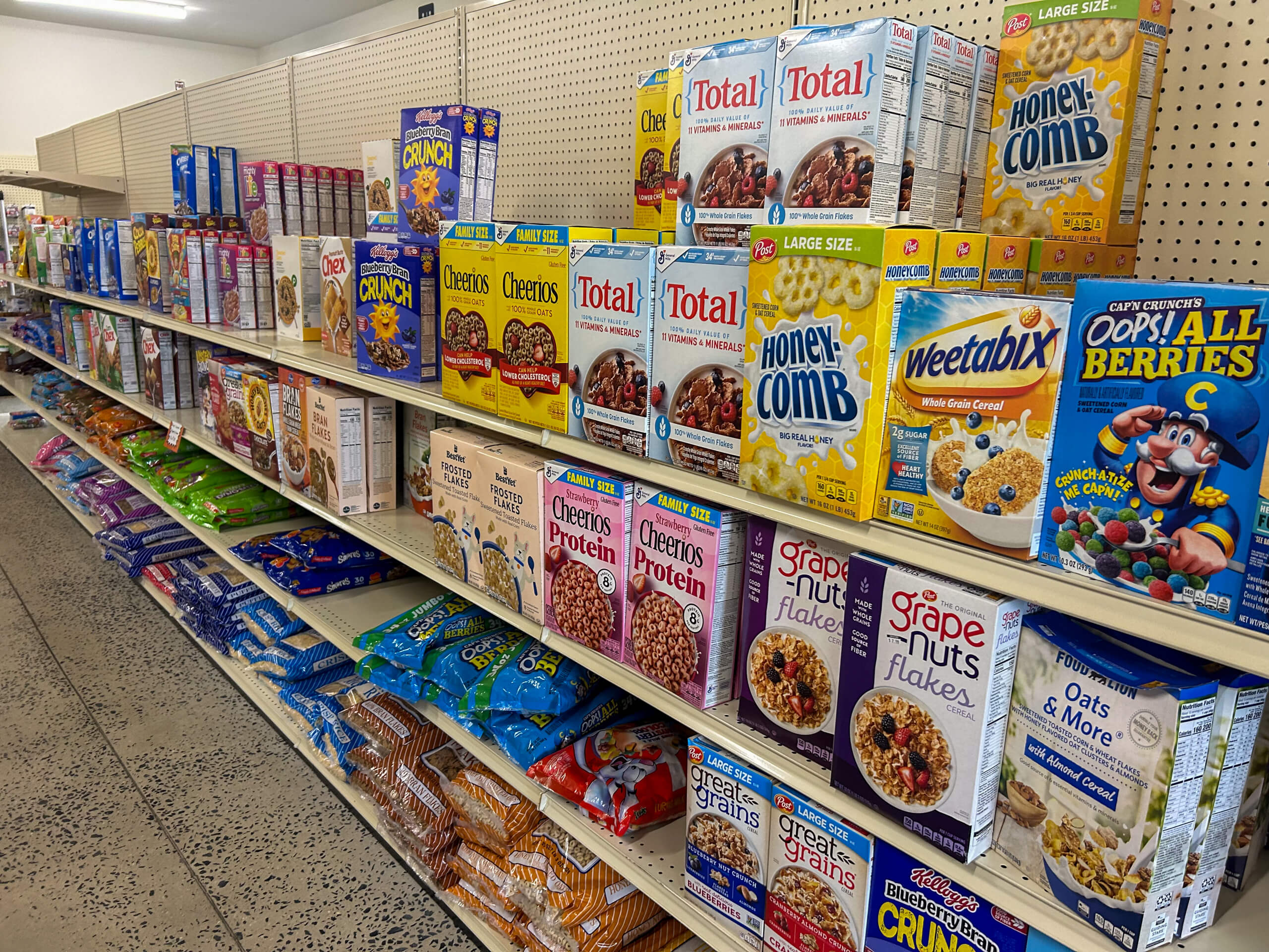 Jamar Groceries Kutztown PA Grocery store aisle with shelves stocked with various breakfast cereals, including Honeycomb, Total, Cheerios, Weetabix, and Cap’n Crunch’s Oops! All Berries.