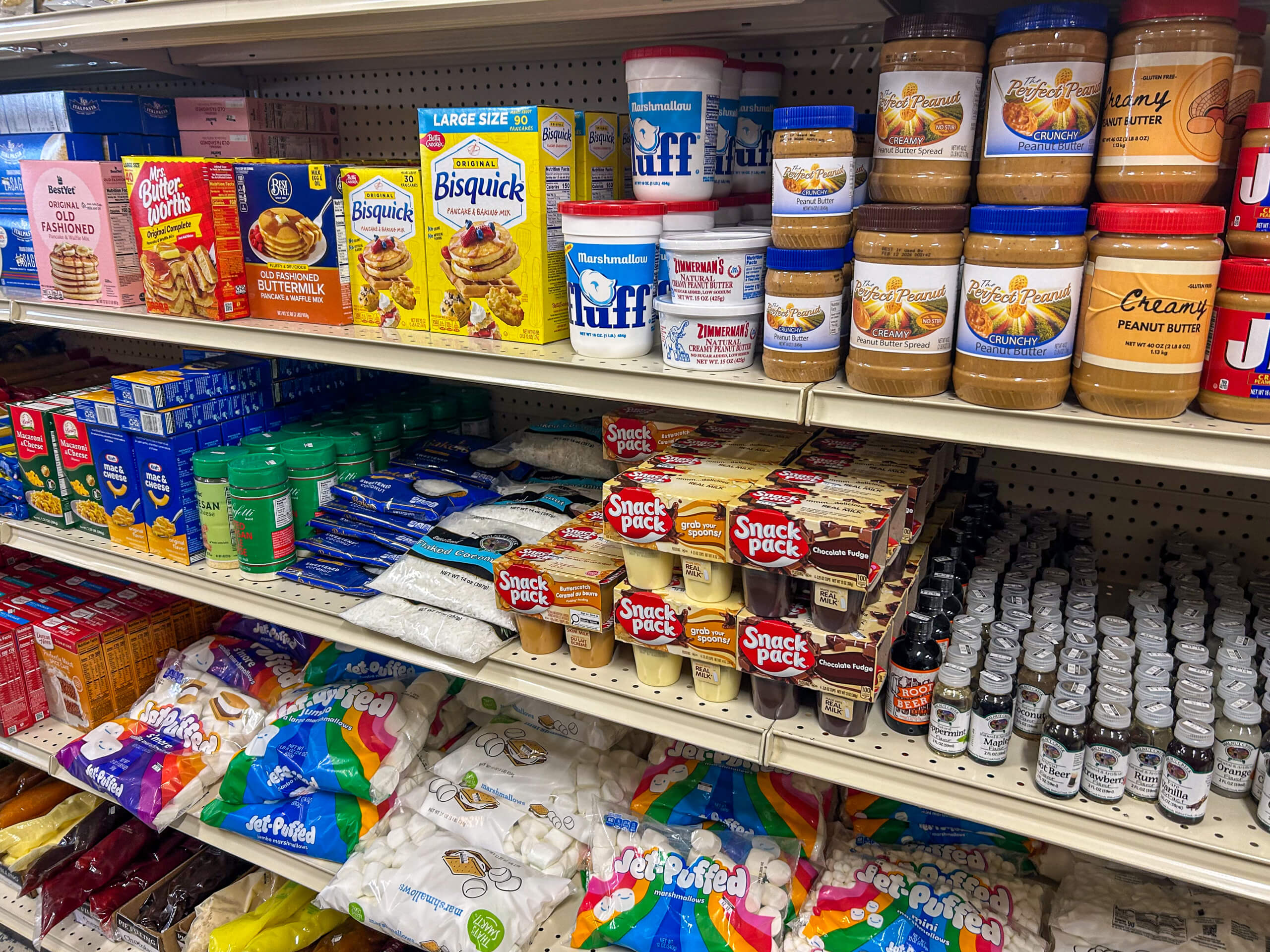 Jamar Groceries Kutztown PA Shelves stocked with baking products, including pancake mix, peanut butter, marshmallow fluff, marshmallows, sweeteners, and baking extracts at a grocery store.