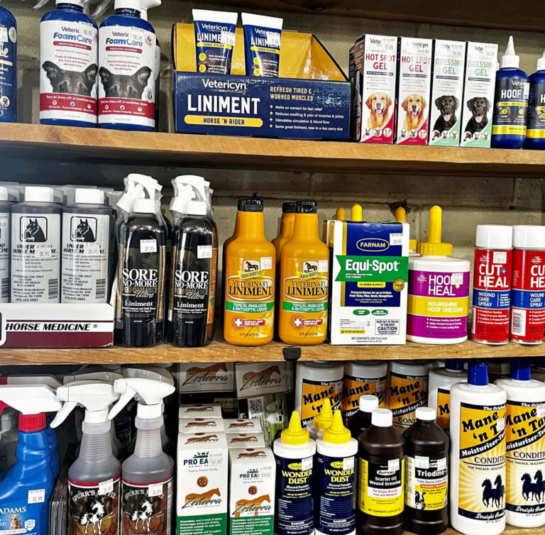 Penchem Tack Store Guthrie, KY Shelves stocked with various animal care and equine health products, including liniments, sprays, supplements, and ointments in bottles, tubs, and boxes.