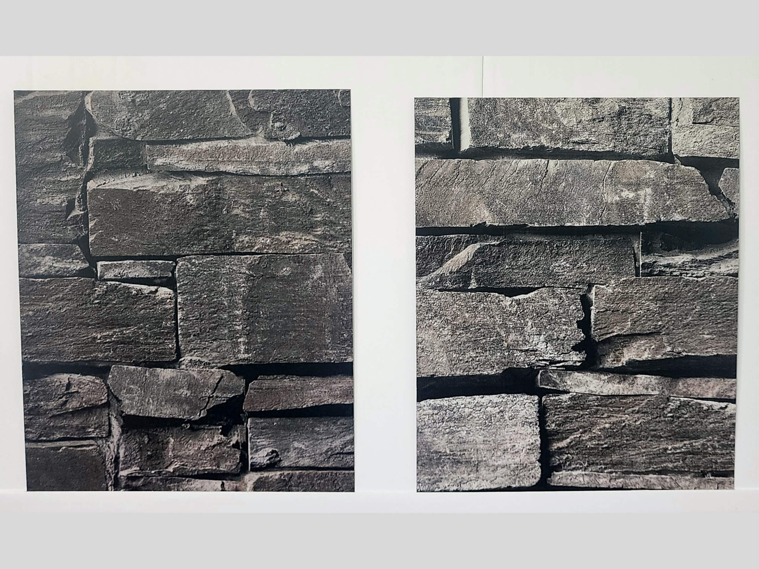 Sunset Metal Roofing and Siding Show Room Ebensburg, PA Two side-by-side photos show close-up views of stacked, uneven gray stone bricks with rough surfaces.